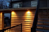 Warm highlights for outdoor patio space illuminating the wooden wall along the staircase