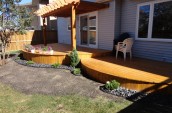 Modern Patio wooden deck with minimal garden in grey stones