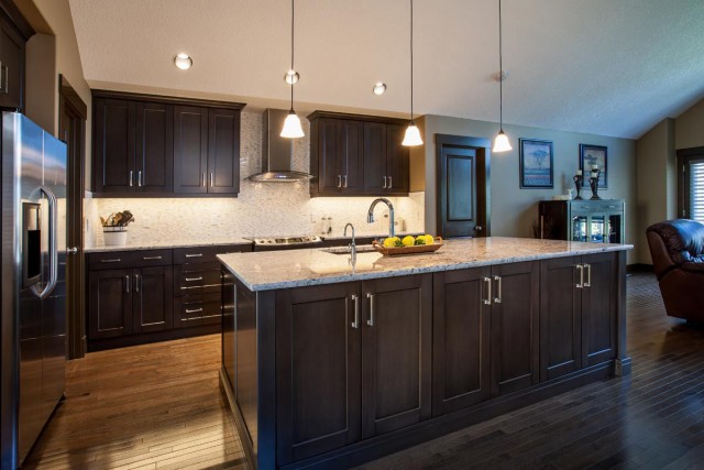 Modern Kitchen Interior in black closets and kitchen island with marble countertop