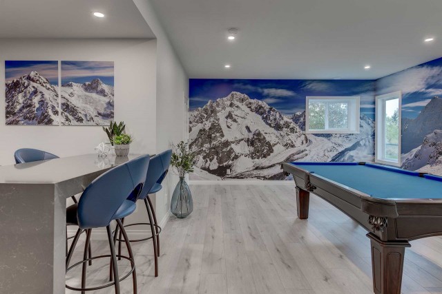pool table in room with mural of a snow-covered mountain