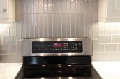 Modern kitchen interior with brand new electric range with unique square shape ventilation fan on the top