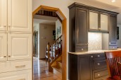 drawers and cabinets either side of a paneled doorway leading to stairs