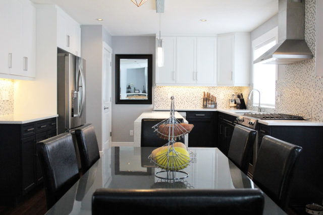 six seater dinner table with kitchenette in background