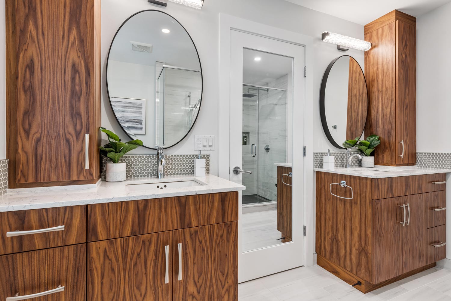 bathroom with wood veneer cabinet and round mirror above basin