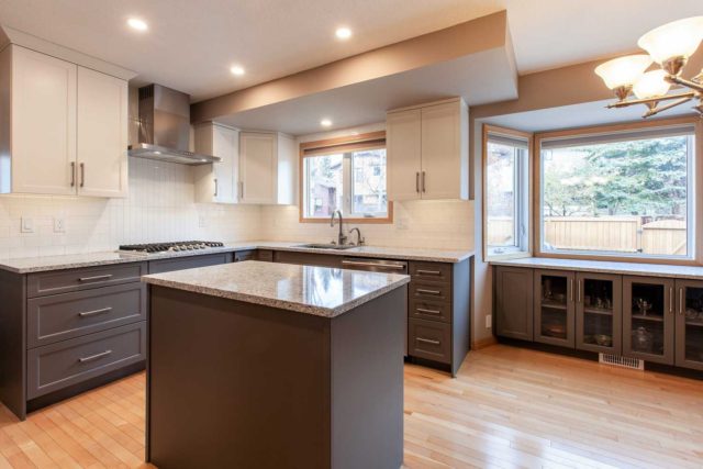 kitchen view showcasing gas hob double sink, windows and workstation