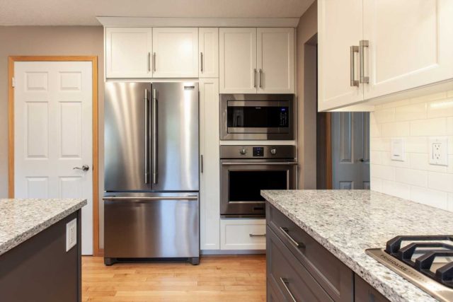 kitchen view showcasing oven and fridge/freezer