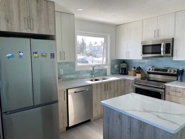 finished kitchen with marble counter tops